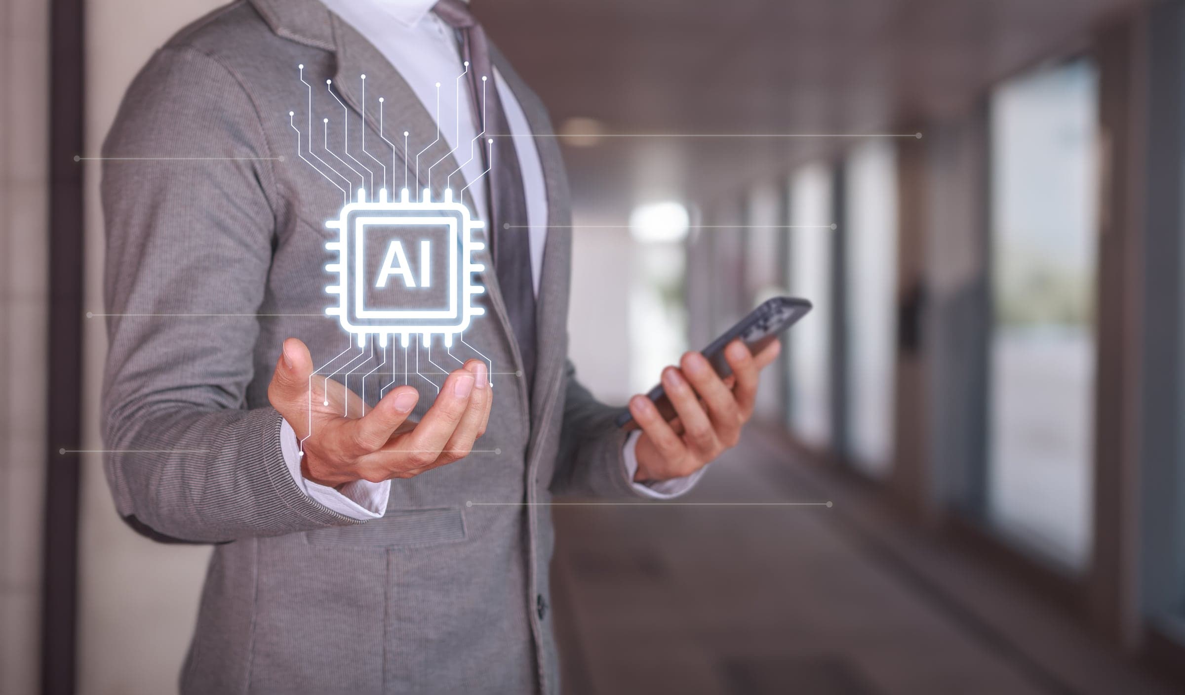 Procurement professional holding a phone with an AI chip hologram above it